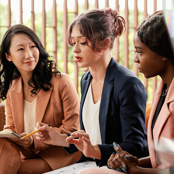 Female lawyer sitting between two women.